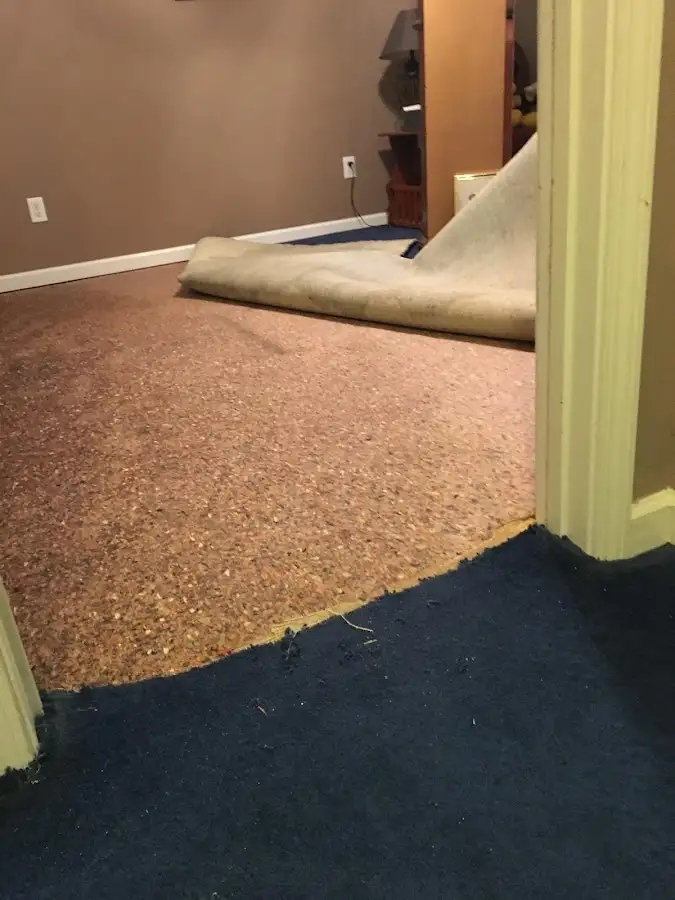 Carpet pad removal revealing water damage during Water Mitigation Services in Hewitt
